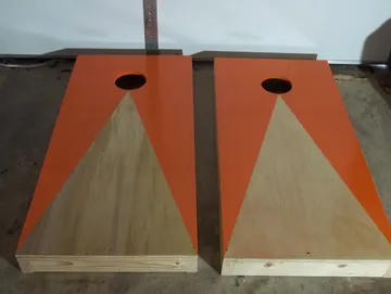 Orange trimmed handmade cornhole boards by Paul's Pens n Things