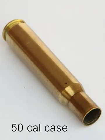 Brass cartridge cases and pen hardware components on a bench